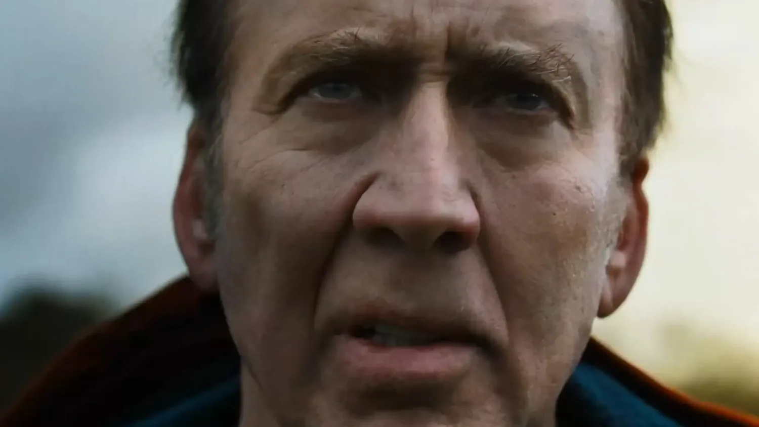Close-up of Nicolas Cage’s face looking intense in the film Arcadian.