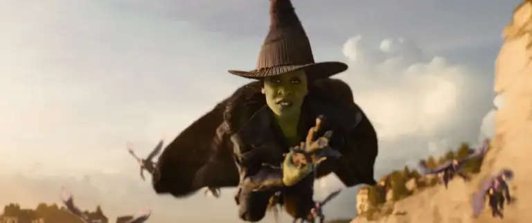 Elphaba flying on her broomstick in Wicked: For Good, the Universal sequel releasing in theaters November 21, 2025.