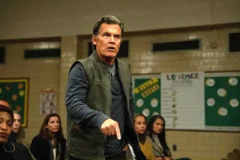 Josh Brolin’s character speaks with intensity during a heated community meeting in Weapons (2025).